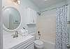 The cozy guest bathroom offers a tub/shower combo, single vanity, and is fully stocked with linens for your stay.