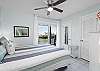 Guest Bedroom: Queen-size bed, chest of drawers and roomy closet—tasteful coastal décor creates a calm, welcoming ambiance. Sliding doors take you to a spacious balcony fully furnished with comfortable seating for extra relaxation.