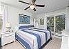 Serene Primary Suite: King-size bed, dresser and generous wardrobe space to stow your belongings neatly away. Step onto the balcony and welcome the morning sun dancing over Little Lagoon.
