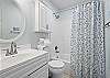 The guest bathroom features a single vanity, tub/shower combo, and is fully stocked with linens for your stay.