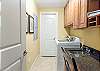 The large laundry room features a full size washer and dryer and is equipped with a sink for handling larger cleaning or soaking tasks. For the remote workers in your group, a desk with chair is offered in this space for convenience of needing private office space.