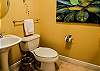 The half bathroom features a single vanity and is fully stocked with linens for convenience.