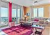 Welcome to Mustique Unit 901. This spacious living area features plenty of cozy seating and gorgeous views of the Gulf. 