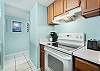 The spacious kitchen features a smooth cooktop range and is fully stocked with all items needed for meal prepping during your stay.
