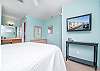 The large bedroom features Queen bedding, mounted television, and plenty of storage for your personal belongings.