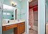 The private bathroom upstairs features an open dressing area and private water closet, which offers a tub/shower combo.