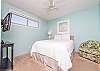 The spacious bedroom features Queen bedding and a private bathroom for convenience.