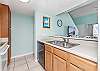 The spacious kitchen offers both small and large appliances and is fully stocked with all items needed for preparing meals during your stay.