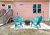 An outdoor area is provided with seating and a small firepit.