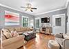 The spacious living area offers plenty of seating and is decorated with a warm, coastal vibe.