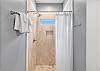 The guest bathroom offers a tiled, standing shower and is fully stocked with linens for your stay.