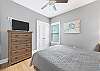 Guest bedroom 2 offers Queen bedding, a chest of drawers and large closet for storing your personal belongings and also a television.