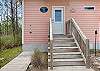 An outdoor shower is located to the left of the front door to help leave the sand and debris on the exterior. 