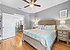 The primary bedroom offers king bedding, bedside tables with lamps and is decorated in a welcoming, warm palette.