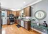 The open kitchen offers stainless appliances which include smooth cooktop range, built in microwave, dishwasher and side by side refrigerator with ice maker.