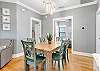 The spacious dining area offers a table with seating for 6