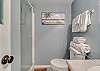 Bathroom 2 offers a standing shower, single vanity and is fully stocked with linens for your stay