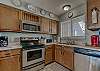 The kitchen is fully stocked with both small and large appliances and all items needed for meal prep