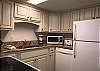 The kitchen offers full size appliances including a microwave, stove, dishwasher and refrigerator. Plenty of cabinetry that is fully stocked with dishes, cookware, pots, pans and utensils makes it convenient to cook meals in