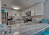 The spacious kitchen offers an eat in bar for convenience of serving extra guests