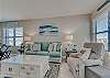 The living area offers a sleeper sofa and 2 chairs for additional seating