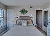 The bedroom offers queen bedding and a small closet for storing your personal belongings out of sight