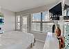 The bedroom offers queen bedding and private balcony access