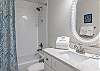 The private, guest bathroom features a single vanity, tub/shower combo, and is fully stocked with linens for your stay.
