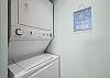 A stack washer/dryer is featured in a laundry closet conveniently located within the kitchen. 