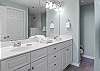 The primary bedroom offers a private bathroom which features a double vanity, tiled shower, and is fully stocked with linens for your stay.