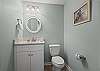 A half bathroom is offered which features a single vanity, and convenient for additional guest use. 