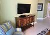 The living area offers a mounted flat screen television for enjoying in your down time