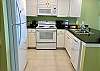 The kitchen offers both small and large appliances and provides a dishwasher, stove, built in microwave and refrigerator