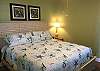 Bedroom 2 offers King Bedding and bedside tables with lamps