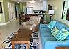 The living area offers a sofa sleeper, recliner and is decorated with a coastal vibe