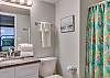 Bathroom 3 offers a private bathroom with a standing shower, single vanity and is fully stocked with linens for your stay