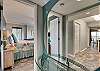 The entry to the master bedroom offers a beautiful mirror and glass topped table which adds to the tasteful decor displayed throughout this unit