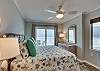 The master bedroom overlooking the Gulf of Mexico offers king bedding, a bedside table with lamp and a small dresser for storing your personal belongings.
