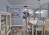 The dining area offers a table with seating for 6 as well as 2 additional seats at the bar