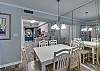 The dining area offers a table with seating for 6 plus 2 additional seats at the adjacent bar