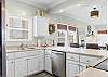 Preparing meals will be a breeze in this fully stocked kitchen which features stainless appliances and a large eat-in style bar with seating.