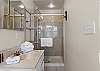 The private bathroom features an ample shower, single vanity, and is fully stocked with linens for your stay.