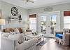 The spacious living area features plenty of comfortable seating and balcony access.