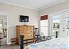 The primary bedroom offers plenty of storage for your personal belongings, a television and balcony access.