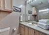 Master Bathroom offers a single vanity, a tub/shower combo and is fully stocked with linens for your stay at Summer Palace