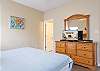 This guest bedroom features Queen bedding, ample storage for your personal belongings, a private bathroom, and a television for enjoying your down time.