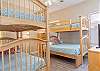 This guest bedroom features a set of Twin bunk beds and also a set of Twin over Full bunk beds. This room can easily sleep 5 regular size guests or all the kids can snuggle in one space. A private bathroom is also featured in this room for convenience.