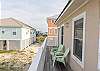 A balcony is featured on the back of the home and offers seating for convenience of enjoying the coastal breezes and sunshine.