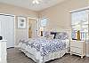 The spacious primary bedroom features king bedding and is beautifully furnished to make you feel right at home. Ample closet and dresser drawers provide plenty of space for storing your personal belongings.