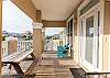 Plenty of seating is featured on the front porch. Pick a spot to relax and enjoy the coastal breeze and salt air. 